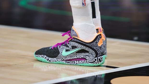 View of black, white, and green Nike KD shoes.